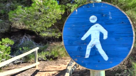 Pedestrian-sign-on-wooden-walkway-at-the-beach-on-a-summer-day