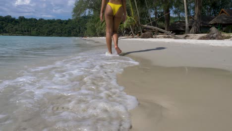 Hot-Asian-model-walking-away,-Low-Angle,-on-a-Tropical-beach,-Koh-Kood,-Thailand
