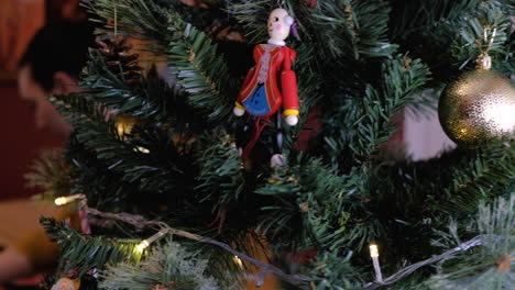 Junge-Schöne-Frau,-Die-Einen-Weihnachtsbaum-Mit-Ornamenten-Und-Lichtern-Aufstellt,-Die-Von-Rechts-Nach-Links-Schwenken