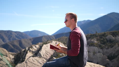 A-man-on-a-hike-alone-thinks-about-his-life-and-future-as-he-writes-in-his-private-journal-and-documents-his-travels-across-California