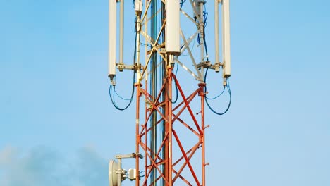 Tilt-Up-Shot-of-cell-tower-against-blue-sky-background-in-Curacao