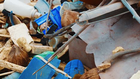 Tilt-up-of-huge-plastic-garbage-pile-littered-on-Caribbean-beach