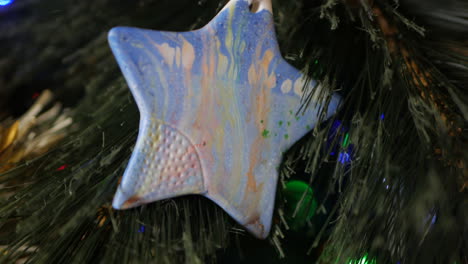 Hand-made-Christmas-star-decoration-hanging-in-a-Christmas-tree