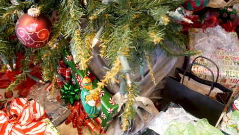 A-Christmas-tree-close-up-with-many-presents-wrapped---downward-sliding-shot