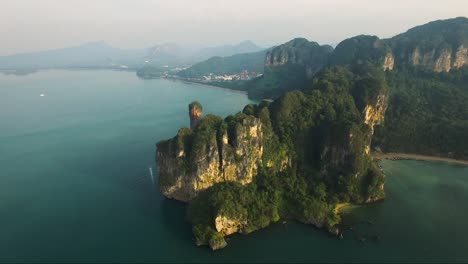 Astonishing-half-turn-aerial-shot-of-limestone-cliffs-on-a-mountainous-tropical-island