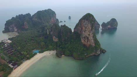 Awesome-aerial-over-a-sandy-tropical-beach-and-past-limestone-cliffs-on-the-coastline