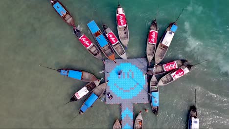 Incredible-overhead-drone-shot-of-boats-docked-at-a-pier-with-a-smiley-face-design