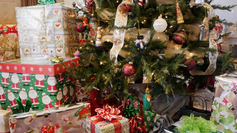 A-Christmas-tree-with-many-presents---sliding-close-up