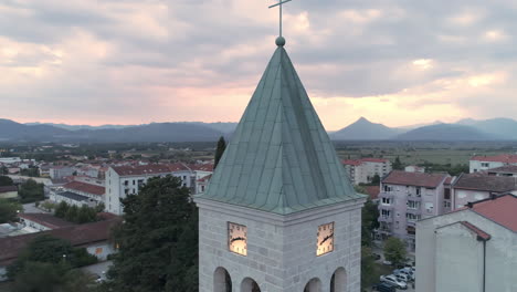 Aerial-360-roll-around-the-local-catholic-church-in-Ljubuski,-Bosnia-and-Herzegovina