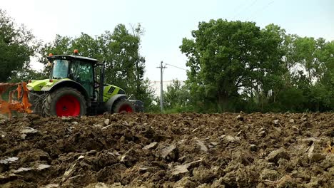 heavy-tractor-passes-and-plows-the-freshly-harvested-land