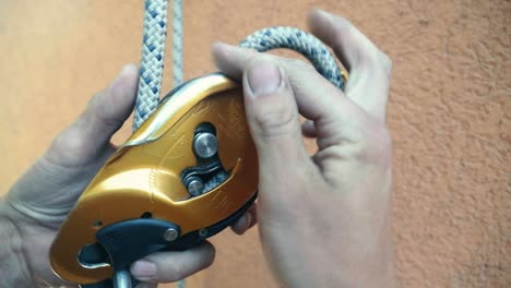 Close-up-view-of-rope-clipping-to-grigri-equipment-ready-for-climbing