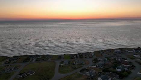 Aerial-view-of-a-Whidbey-Island-waterfront-neighborhood-during-a-glowing-sunset