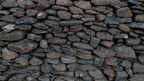 Close-up-panning-shot-of-a-hand-built-asymmetrical-stone-wall