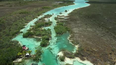 Reverse-drone-shot-of-the-river-of-Los-Rapidos-de-Bacalar