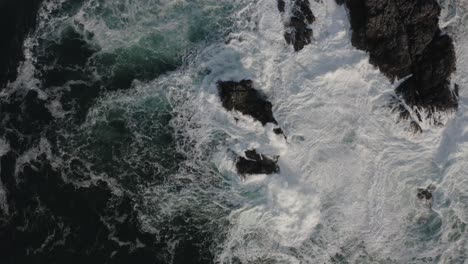 Drone-shot-of-rough-waves-hitting-a-rock-on-Vancouver-Island,-British-Columbia