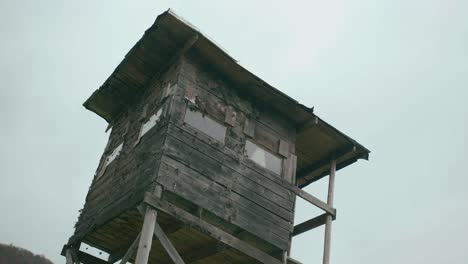 Detail-of-a-hunting-cabin-with-a-cloudy-sky-in-the-background