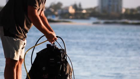 Person-setting-up-scuba-diving-equipment