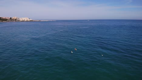 Kayaks-In-Open-Sea-At-Costa-del-Sol-Beach,-Estepona,-Spain---aerial-drone-shot