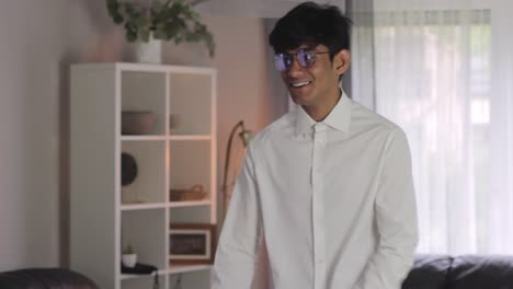 Young-and-Happy-Asian-Man-Smiling-while-Getting-Dressed-Formally