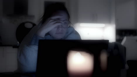 Woman-checking-work-emails-late-at-night-in-front-of-laptop,-blurry-view