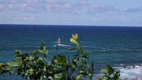 3-wind-sports-at-Hookipa-Beach-Point,-windsurfing,-wing-foiling,-kite-surfing