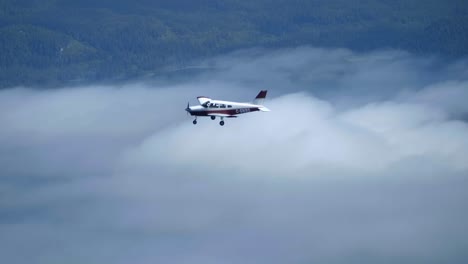 A-Small-Airplane-Flying-Above-the-Clouds,-Air-to-Air-View