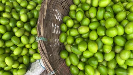 Top-shot-of-fresh-lime-kept-in-handmade-basket-in-local-market-in-Bangladesh