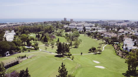 Aerial-fly-over-of-a-luxurious-golf-course-in-Marbella,-Spain