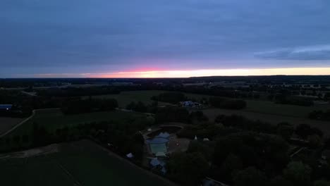 Aerial-Late-Evening-View-Of-Glamping-Park-At-North-Limburg-During-Setting-Sun-On-Horizon