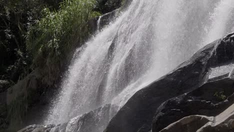 Close-mid-shot-of-cascading-waterfall-against-rocky-surface