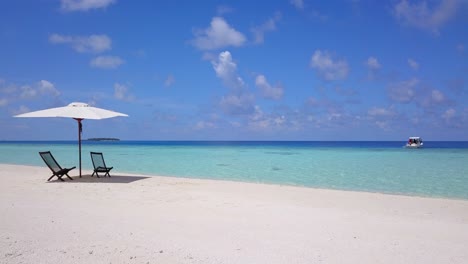 Tranquil-scene-with-empty-sun-chairs-on-crisp-white-beach