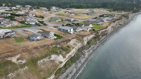 Drone-shot-of-houses-perched-on-the-edge-of-an-eroding-bluff-on-Whidbey-Island