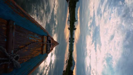 Vertikale-Aufnahme-Eines-Blau-Lackierten-Alten-Holzbootsbogens-Auf-Ruhigem-Wasser-Des-Dal-sees-In-Srinagar,-Kaschmir,-Indien