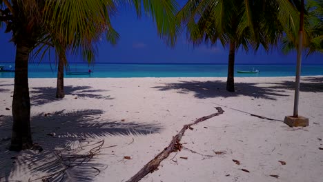Palms-on-white-sandy-beach,-jib-shoot-on-beautiful-Maldives-island-getaway