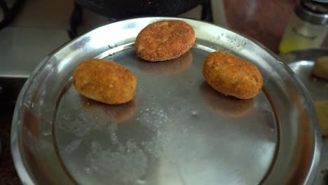 Freshly-Cook-Potato-Cutlet-Placing-In-Silver-Plate