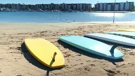 Chilling-on-the-beach,-with-surfboards-lined-up-in-a-tandem-at-the-beach-of-Santa-Monica-California