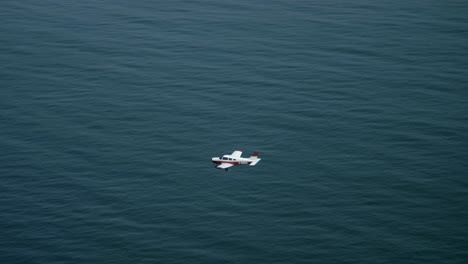 Light-Private-Single-Engine-Airplane-Flying-Above-the-Sea,-Air-to-Air
