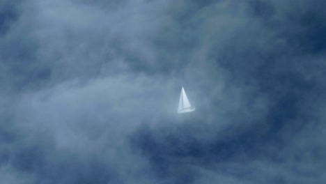 Sailboat-Sailing-on-the-Calm-Ocean,-Aerial-View-Airplane,-Thin-Clouds