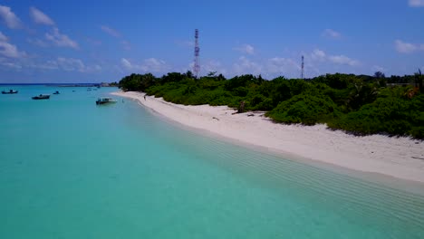 aerial-footage-along-the-coast-of-a-tropical-island-with-palm-trees-on-the-white-sandy-beaches