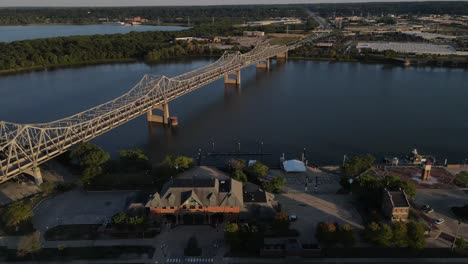 Aerial-flight-over-the-Illinois-River-Bridge,-Murray-Baker,-Route-150,-War-Memorial-Drive,-Peoria,-Illinois-at-sunset