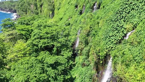 Aerial-drone-view-of-the-Anse-des-Cascades-waterfalls-on-Reunion-Island,-a-french-overseas-department-in-the-Indian-Ocean