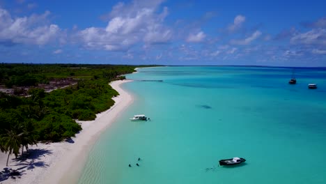 aerial-view-of-a-Carribean-island-as-the-drone-traces-on-the-white-sandy-beach-as-the-turquoise-water-hit-the-shores