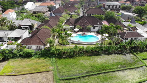 Aerial-zoom-out-from-a-luxury-swimming-pool-in-Bali