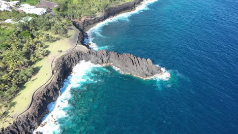 Aerial-view-over-the-Lava-rock-formation-of-Cap-Mechant-and-the-coastline-of-Reunion-Island
