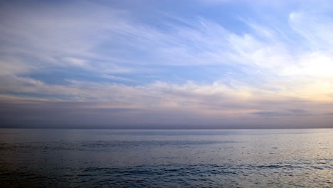 End-of-the-day,-on-the-calm-serene-waters-of-Big-Rock-Malibu-California-with-passing-clouds
