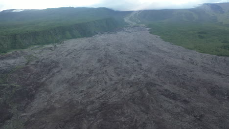 Aerial-flight-over-the-dried-lava-flow-from-a-volcanic-eruption-on-Reunion-Island