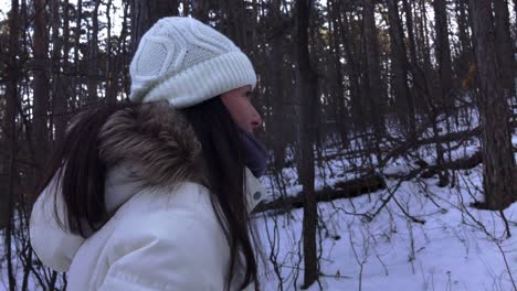 Woman-walking-alone-in-a-snowy-mountain