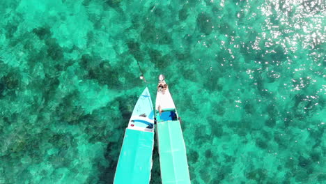 Aerial-view-of-traditional-boats-on-crystal-clear-turquoise-water-in-Indonesia