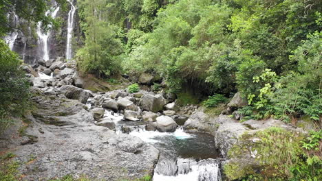 Drone-flight-over-a-river-and-small-waterfall-leading-to-Grand-Galet-Falls-at-the-Cascade-Langevin-on-the-island-of-Réunion