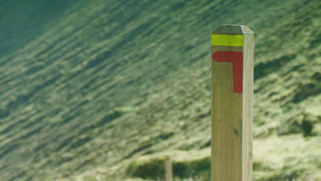 Close-up-of-a-trail-marker-post-on-the-slopes-of-the-Caldeira-volcano,-the-Azores